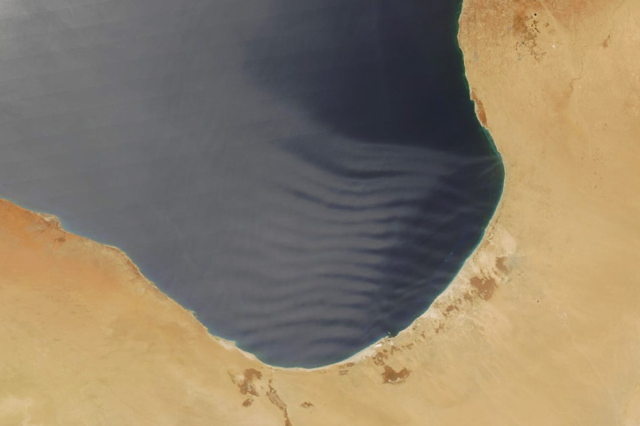 Dusty Waves Over the Gulf of Sidra