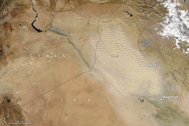 Satellite image showing a cloud of dust originating between the Tigris and Euphrates rivers and blowing south-southeast across Iraq. The plume contains parallel bands reminiscent of ripples on a pond.