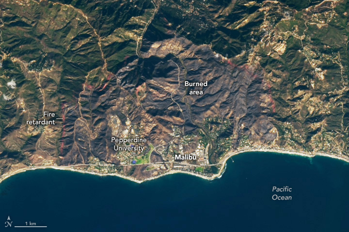 A satellite image of Malibu, California, on December 13, 2024, which shows vegetation burned from the Franklin Fire and a red line of fire retardant in the hills near the perimeter of the fire.