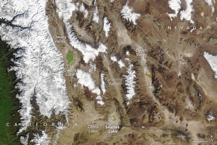 A natural-color image from MODIS shows the mostly dry lakebed of Searles Lake with several neighboring dried lakes in nearby valleys. Snow-covered (white) mountain ranges surround the valleys (brown) containing the lakes. The lakes are in southern California.