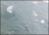 Waves on White: Ice or Clouds